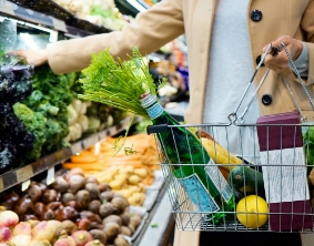 Someone filling a Basket of groceries